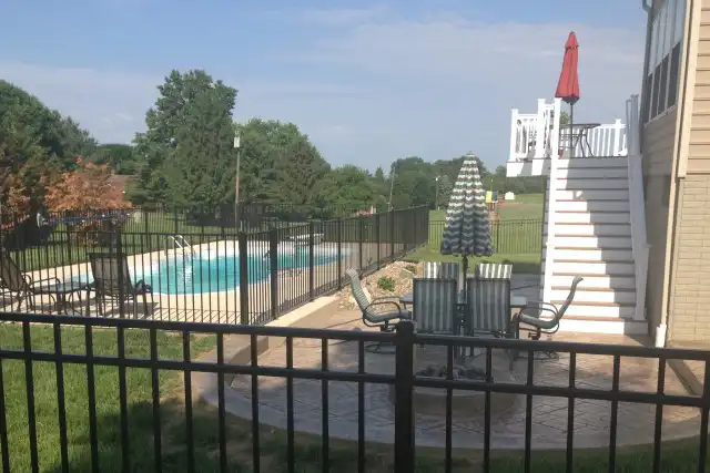 Custom white deck and stairs leading to backyard pool